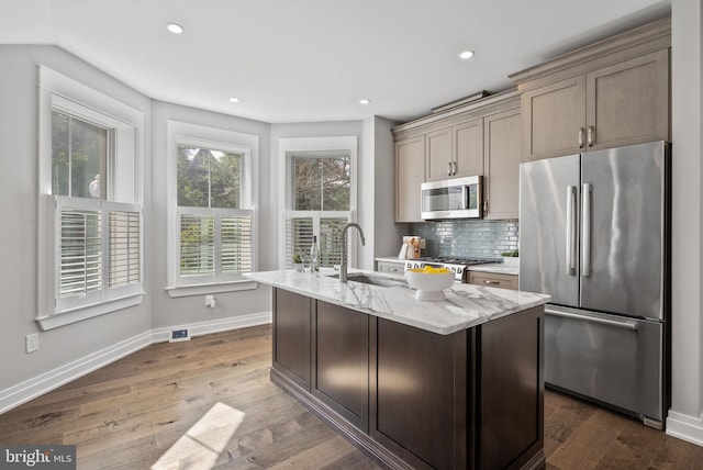 900 11th St NE Unit 1, Washington, DC 20002 - kitchen with decorative backsplash, light stone countertops, dark wood finished floors, appliances with stainless steel finishes, and a sink