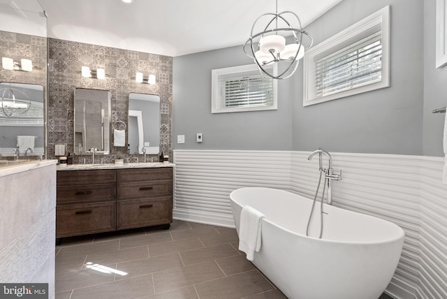 900 11th St NE Unit 1, Washington, DC 20002 - full bathroom with an inviting chandelier, a sink, a freestanding bath, double vanity, and wainscoting