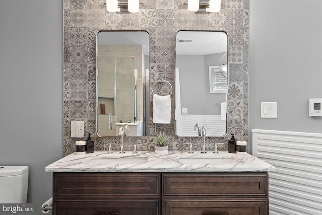 900 11th St NE Unit 1, Washington, DC 20002 - full bath featuring visible vents, a sink, toilet, and double vanity