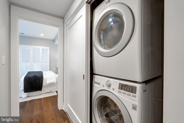 900 11th St NE Unit 1, Washington, DC 20002 - laundry room featuring dark wood-style flooring, stacked washer / dryer, and laundry area