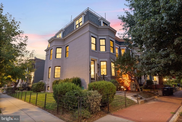 900 11th St NE Unit 1, Washington, DC 20002 - view of front of home featuring a fenced front yard, mansard roof, and brick siding
