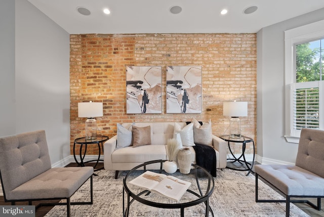 900 11th St NE Unit 1, Washington, DC 20002 - living room featuring brick wall, baseboards, and wood finished floors