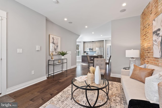900 11th St NE Unit 1, Washington, DC 20002 - living area featuring dark wood-style floors, brick wall, recessed lighting, and baseboards
