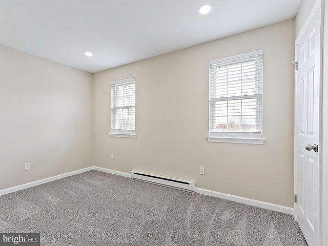 empty room featuring baseboard heating, baseboards, and recessed lighting