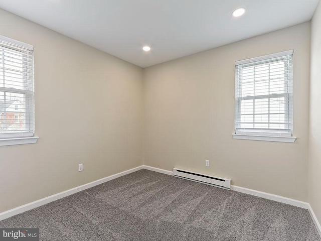 spare room featuring a healthy amount of sunlight, recessed lighting, baseboards, and baseboard heating