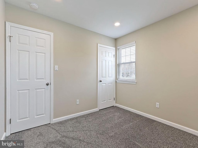 unfurnished bedroom with carpet and baseboards