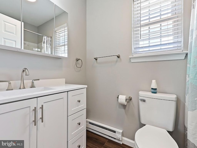 full bath featuring vanity, baseboards, toilet, a baseboard radiator, and wood finished floors