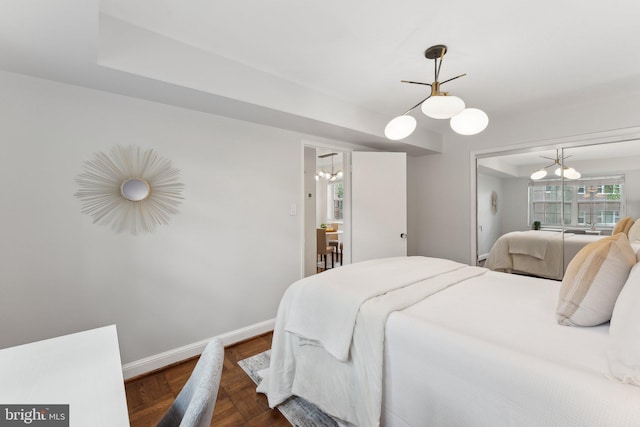 1336 N Ode St Unit 5, Arlington, VA 22209 - bedroom featuring a chandelier, baseboards, and parquet flooring