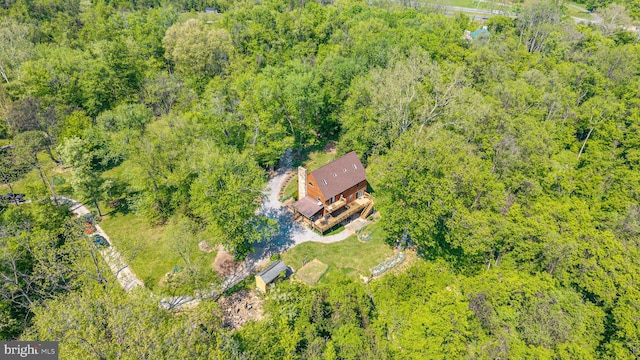 drone / aerial view featuring a wooded view