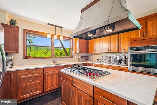 kitchen with appliances with stainless steel finishes, brown cabinetry, island exhaust hood, and a sink