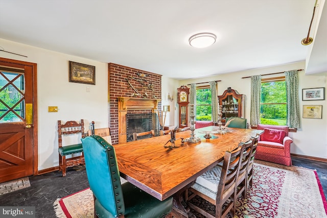 dining room featuring a fireplace and baseboards