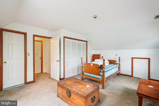 bedroom with vaulted ceiling, baseboards, and light carpet