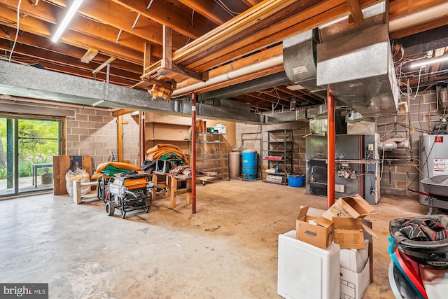 basement featuring water heater, heating unit, and concrete block wall