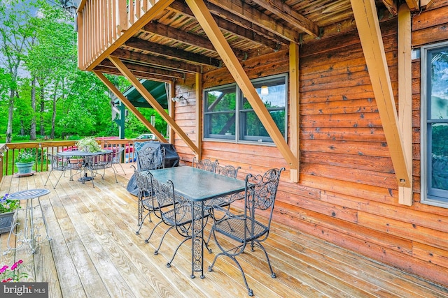 wooden terrace with outdoor dining space