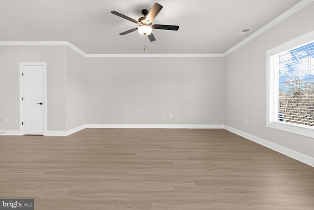 interior space with light wood-style flooring, ornamental molding, visible vents, and a ceiling fan