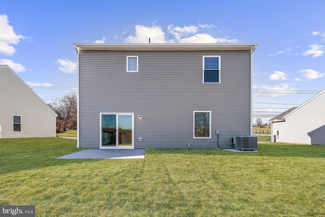 back of property with a lawn, a patio area, and central AC