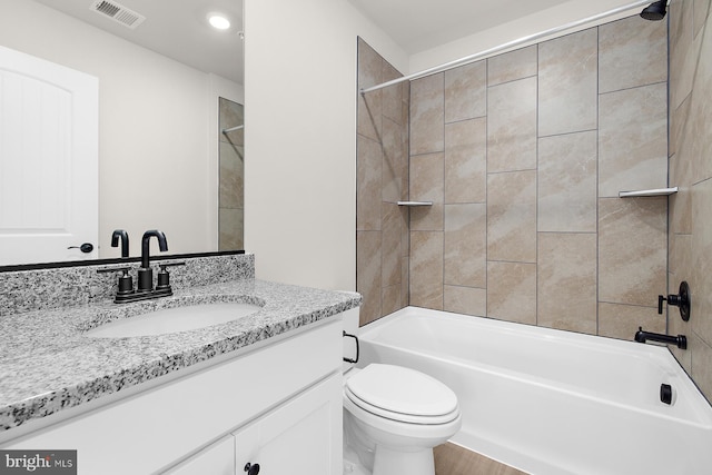 bathroom with toilet, vanity, bathtub / shower combination, and visible vents