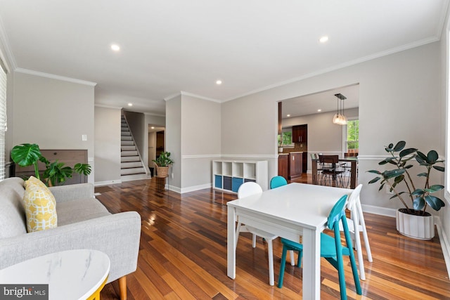 dining space featuring recessed lighting, stairway, wood finished floors, baseboards, and ornamental molding