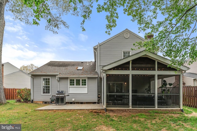 back of property featuring a sunroom, a patio area, and roof with shingles