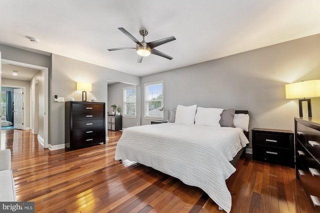 bedroom with hardwood / wood-style flooring, baseboards, and ceiling fan