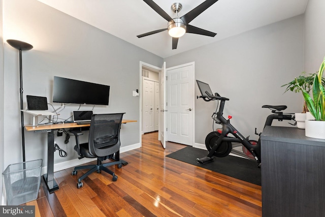 office featuring ceiling fan, wood finished floors, and baseboards