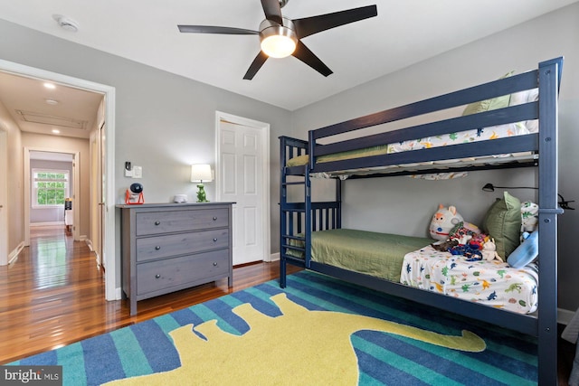 bedroom with wood finished floors, baseboards, and ceiling fan