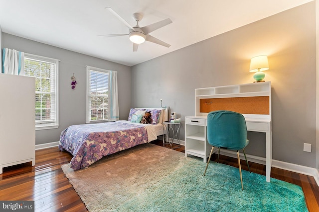 bedroom with hardwood / wood-style floors, baseboards, and a ceiling fan