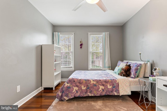 bedroom with wood finished floors, a ceiling fan, and baseboards