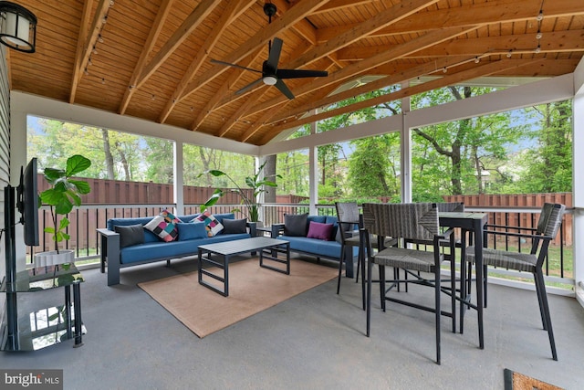 view of patio / terrace with an outdoor living space, a fenced backyard, a ceiling fan, and outdoor dining space
