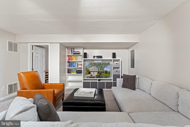 living room with carpet, electric panel, baseboards, and a textured ceiling
