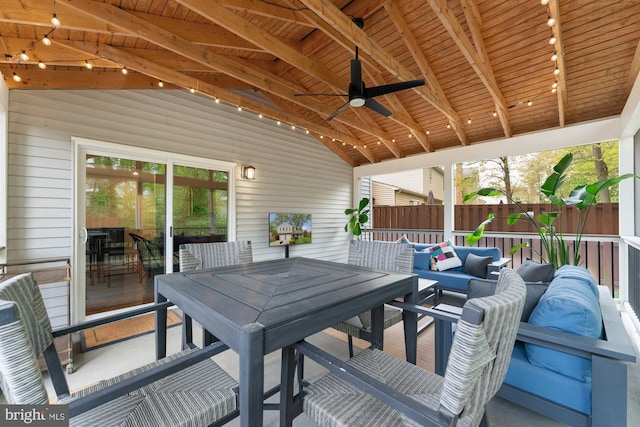 view of patio / terrace with a ceiling fan, fence, and outdoor dining space
