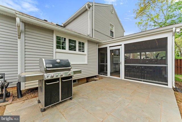 view of patio with a sunroom and a grill