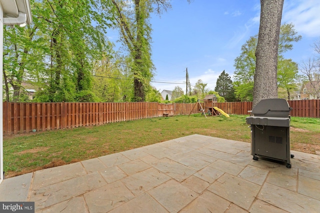 view of patio with a playground and a grill