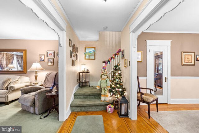 stairs with baseboards and ornamental molding