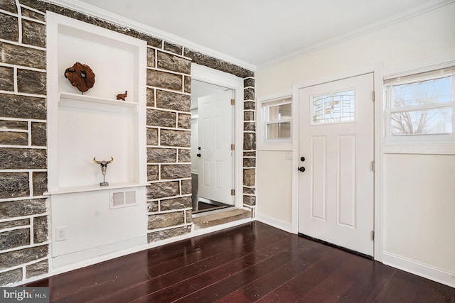 foyer entrance featuring hardwood / wood-style flooring, crown molding, and baseboards