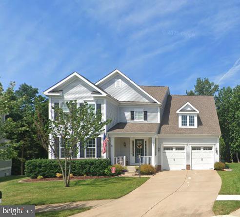 187 Verbena Dr, Stafford, VA 22554 - view of front of house with driveway, a garage, a front lawn, and a porch