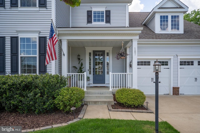 187 Verbena Dr, Stafford, VA 22554 - entrance to property with concrete driveway, a porch, and a shingled roof