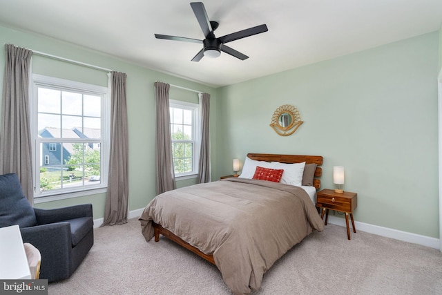 187 Verbena Dr, Stafford, VA 22554 - bedroom featuring multiple windows, baseboards, light colored carpet, and a ceiling fan