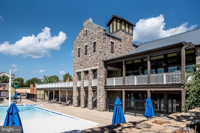 187 Verbena Dr, Stafford, VA 22554 - rear view of house featuring stone siding and a community pool
