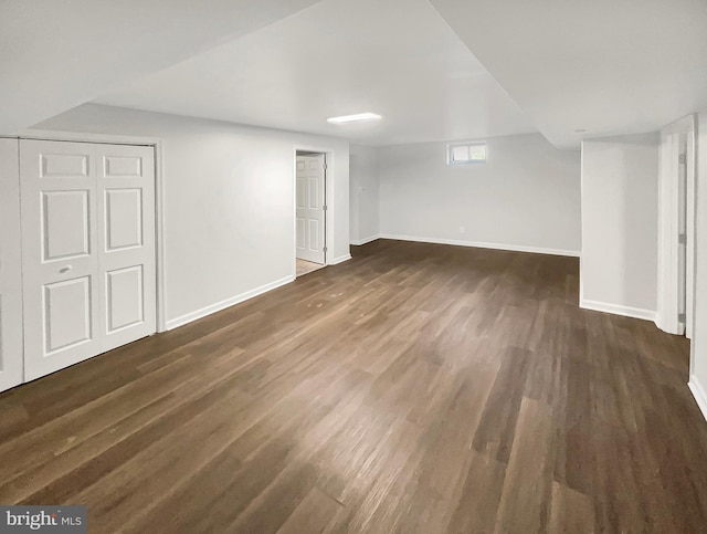 below grade area with baseboards and wood finished floors