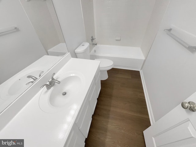 bathroom with toilet, shower / bathtub combination, vanity, and wood finished floors