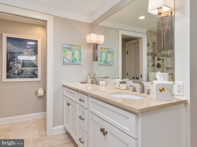 bathroom with a sink, baseboards, tiled shower, and double vanity