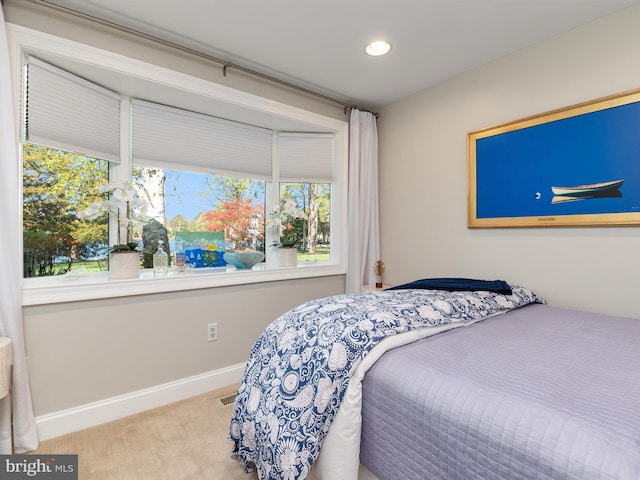 carpeted bedroom with visible vents, baseboards, and recessed lighting