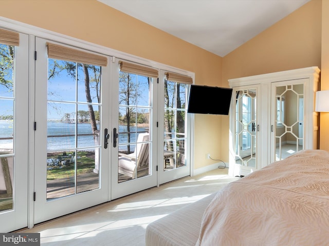 bedroom with carpet flooring, french doors, access to exterior, and lofted ceiling