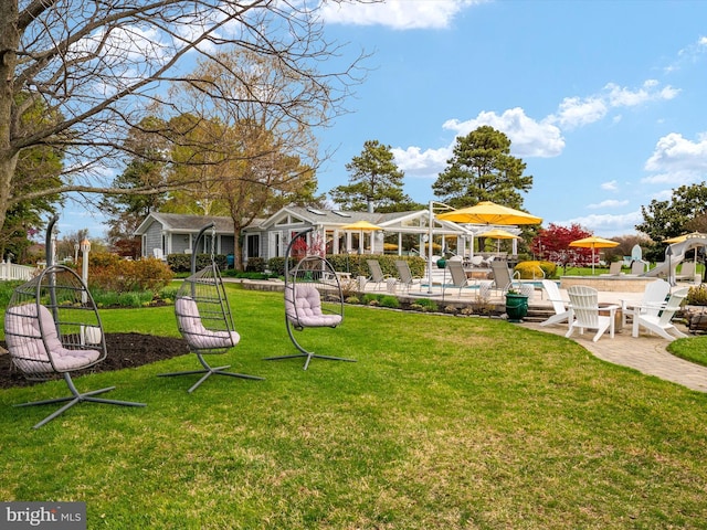 view of yard featuring a swimming pool, a patio, and fence