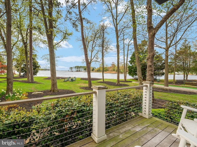 wooden deck with a yard and a water view