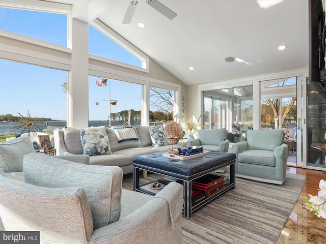 sunroom with a water view and beamed ceiling