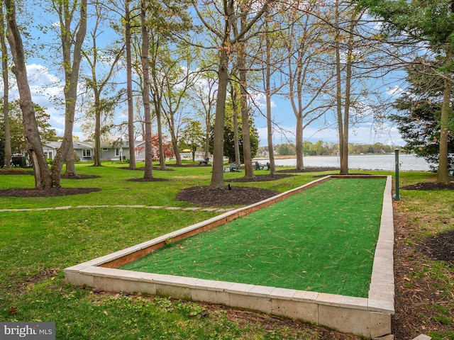 view of community with a water view and a lawn