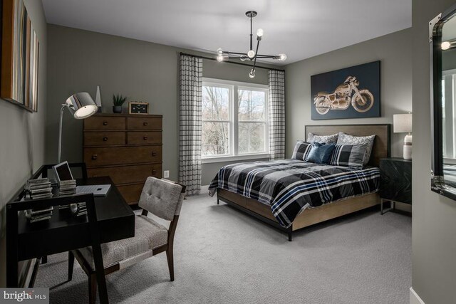 bedroom featuring carpet floors, a notable chandelier, and baseboards