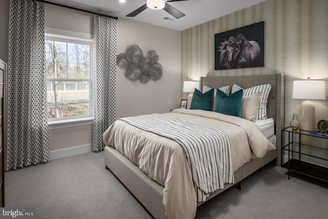 bedroom featuring carpet floors, baseboards, multiple windows, and visible vents